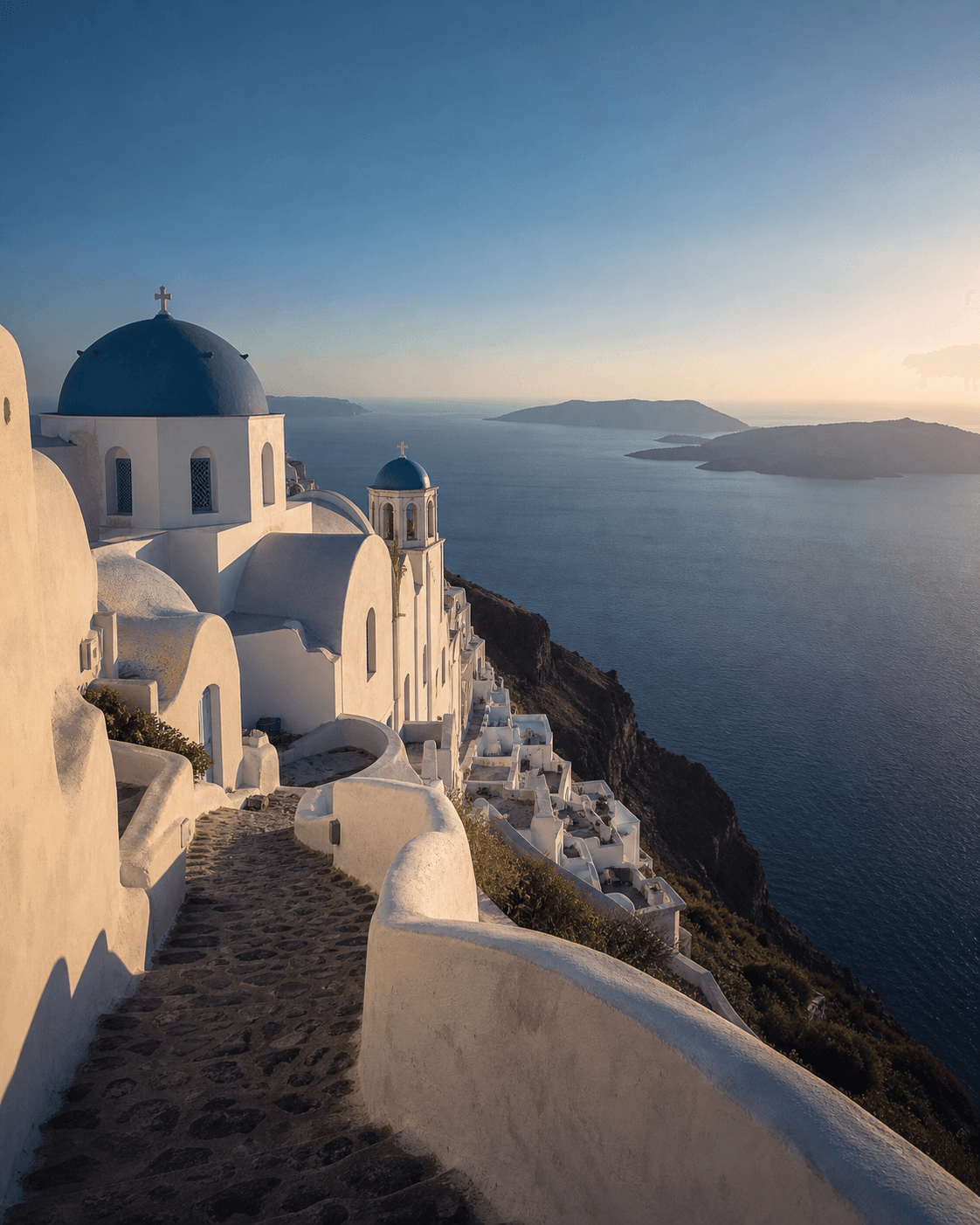 Whitewashed churches overlooking the Aegean Sea in Santorini, Greece.